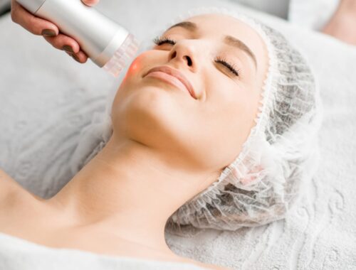 Woman receiving radio frequency treatment on face